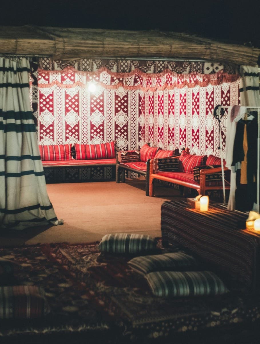 Floor-level seating, rich fabrics, and the geometry of hospitality — the room where everyone gathers.